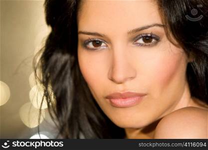 A stunningly beautiful young hispanic woman looking sultry