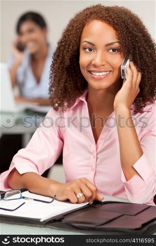 A stunningly beautiful young mixed race African American woman talking happily on her cell phone
