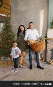 A stylish happy family is decorating their home and preparing for Christmas celebration in their country house