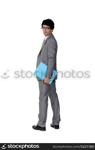 A suave businessman holding a file