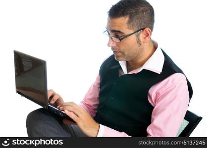 A successful businessman with glasses wearing vest and pink shirt looking at a little computer