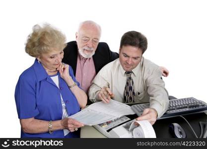 A successful senior couple going over figures with their accountant.