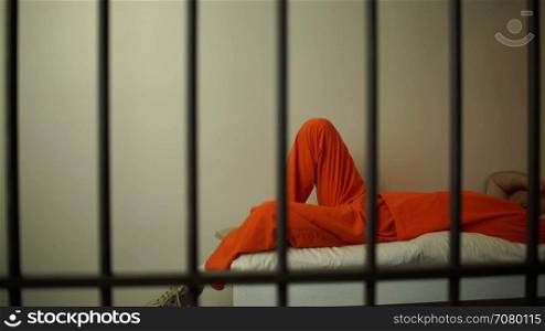 A suicidal inmate in prison laying on bed
