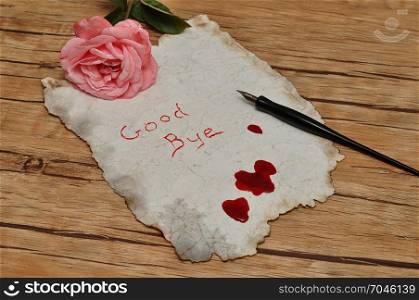 A suicide note on an old paper covered in blood with a vintage fountain pen and a pink rose
