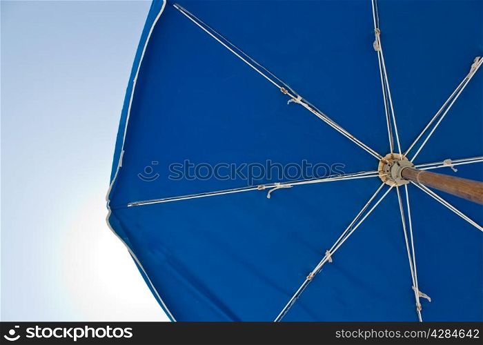 A sun umbrella providing shade on a sunny day