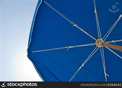 A sun umbrella providing shade on a sunny day