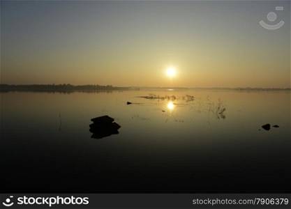 a sunrice on the Lake Amnat Charoen in the city of Amnat Charoen in the Provinz Amnat Charoen in the northwest of Ubon Ratchathani in the Region of Isan in Northeast Thailand in Thailand.&#xA;