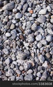 A surface texture of coastal small rocks - background surface
