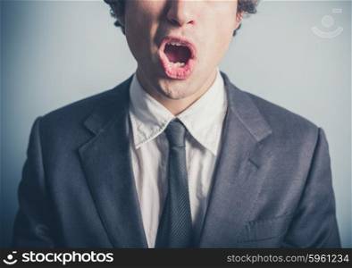 A surprised young businessman with his mouth open