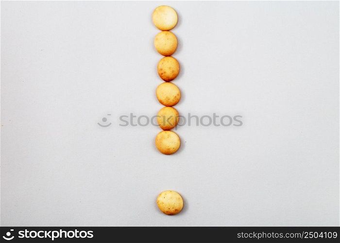a sweet biscuits laid out in the shape of a exclamation point. sweet biscuits laid out in the shape of a exclamation point
