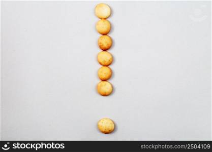 a sweet biscuits laid out in the shape of a exclamation point. sweet biscuits laid out in the shape of a exclamation point