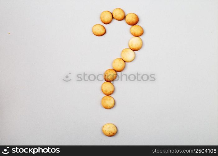 a sweet biscuits laid out in the shape of a question mark. sweet biscuits laid out in the shape of a question mark