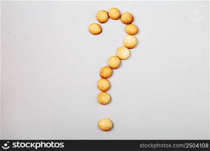a sweet biscuits laid out in the shape of a question mark. sweet biscuits laid out in the shape of a question mark