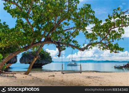 A swing on a tree on the beach of an uninhabited island in Thailand