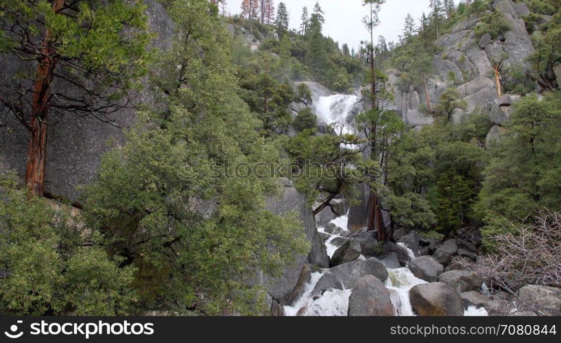 A swollen spring river crashes over rocks in Yosemite