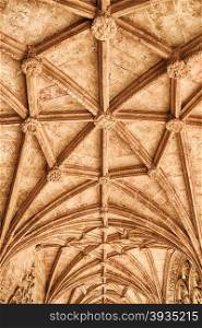 A symmetrical pattern of stone beams forms the vaulted ceiling of a hallway in the Jeronimos Monastery in the Belem distrcit of Lisbon, Portugal.