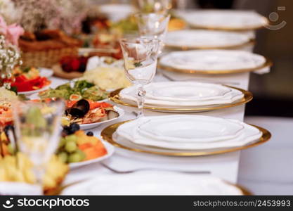 a table with a tablecloth, a beautiful serving of white dishes, a beautiful plate, dinner in a restaurant.. a table with a tablecloth, a beautiful serving of white dishes, a beautiful plate, dinner in a restaurant