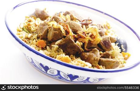 A tagine bowl of Saudi Arabian-style kabsa shot and processed for a high-key effect.