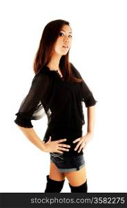 A tall and pretty chinese woman in a black blouse and long black bootsstanding in the studio for white background.