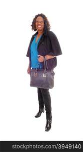 A tall smiling African American woman in black tights and jacket holdingher handbag, smiling, isolated for white background.