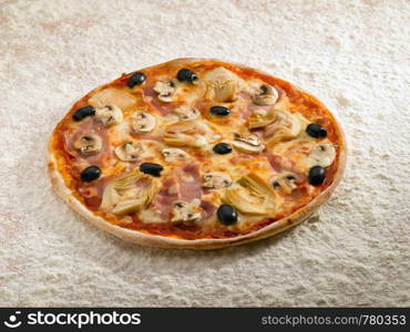 A tasty pizza cappriciosa on a bed of flour.
