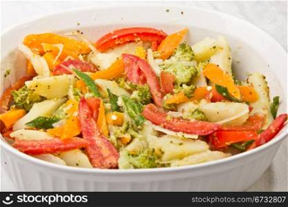 A tasty salad with tomatoes, onions, Broccoli and lettuce served in a bowl