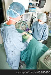 A team doing surgery in a small operating room