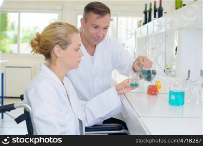 a team of chemists mixing the liquids