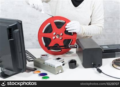 a technician with white gloves digitalizing a 16mm film