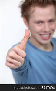 A teenage boy giving the thumb up.