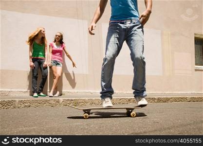 A teenage boy skateboarding