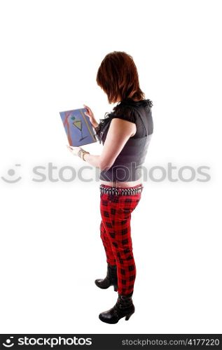 A teenage girl in red chequered pants and boots standing in the studioand show her own painting, for white background.