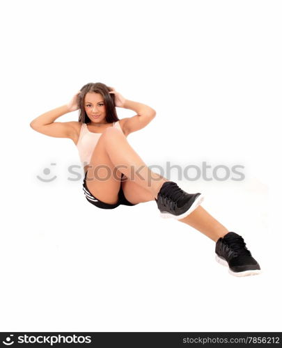 A teenage girl lying on the floor doing sit-ups, isolated on white background.