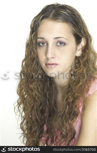 A teenage model in a pink top with great curly hair