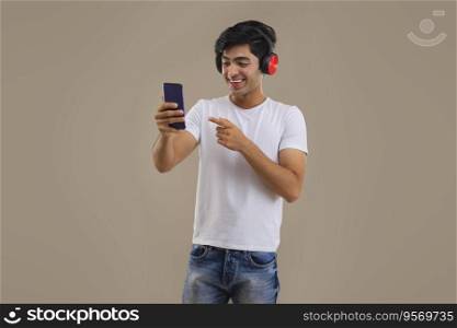 A TEENAGER LAUGHING WHILE VIDEO CALLING ON MOBILE