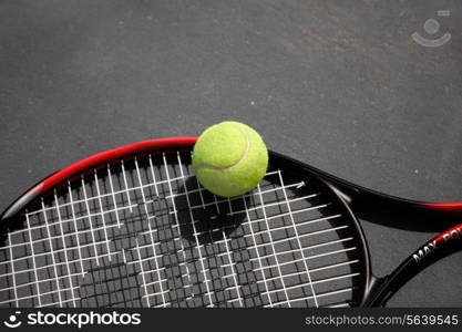 A tennis racket and ball