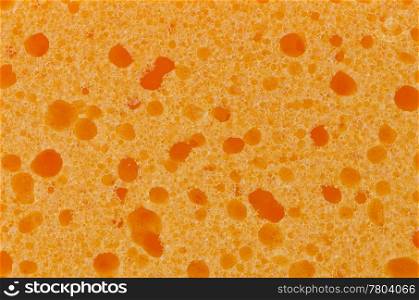 A texture of orange sponge, closeup detail background.