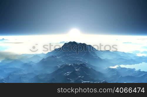 A thick white mist and clouds cover the blue mountains. From - for the horizon the sun slowly rises white. The entire landscape in white and blue colors.