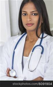 A thoughtful Indian Asian female medical doctor arms folded in a hospital office with stethoscope&#xD;