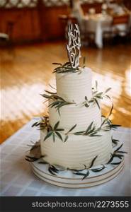 A three-tiered cake with white and green coloring.. The original greenish cake with flowers 3959.