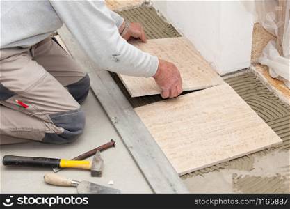 a tiler laying a tiled marble
