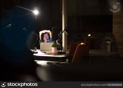 A time for relax. Young tired casual businessman relaxing at the desk in his night office