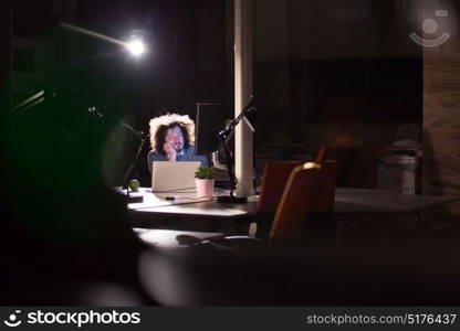 A time for relax. Young tired casual businessman relaxing at the desk in his night office