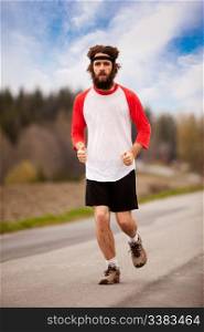 A tired retro style jogger running on a road outdoors