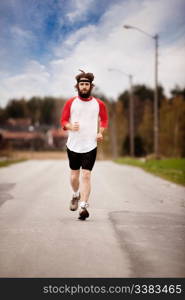 A tired retro style jogger running on a road outdoors