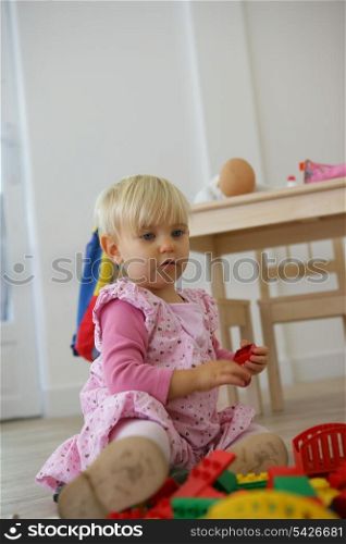 A toddler playing with her toys