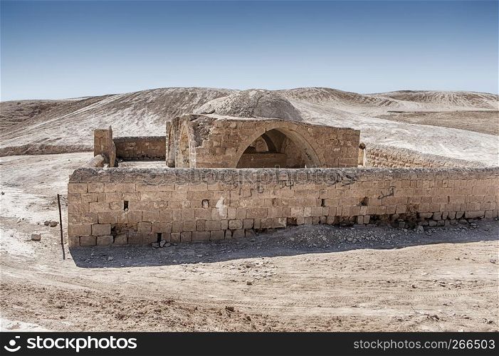 A tomb with a surrounding wall made of stone stands in the middle of the Negev Desert In Israel.