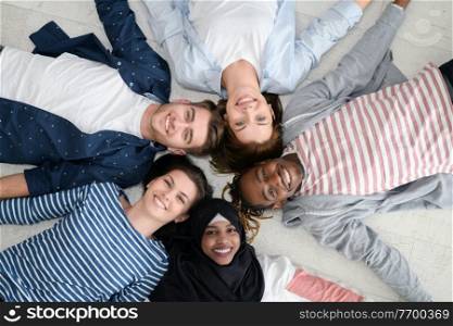 a top view of a diverse group of people lying on the floor and symbolizing togetherness 