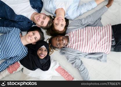 a top view of a diverse group of people lying on the floor and symbolizing togetherness
