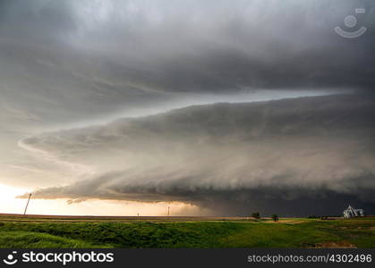 A tornado-producing supercell thunderstorm spinning over ranch land near Leoti, Kansas